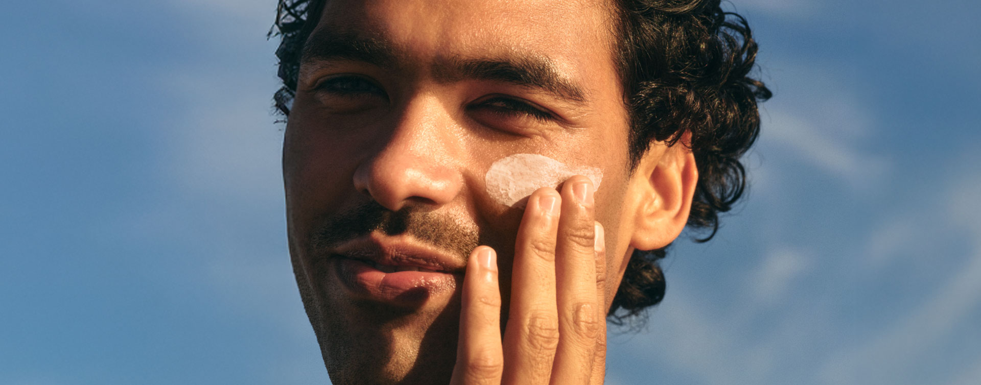 man applying skincare